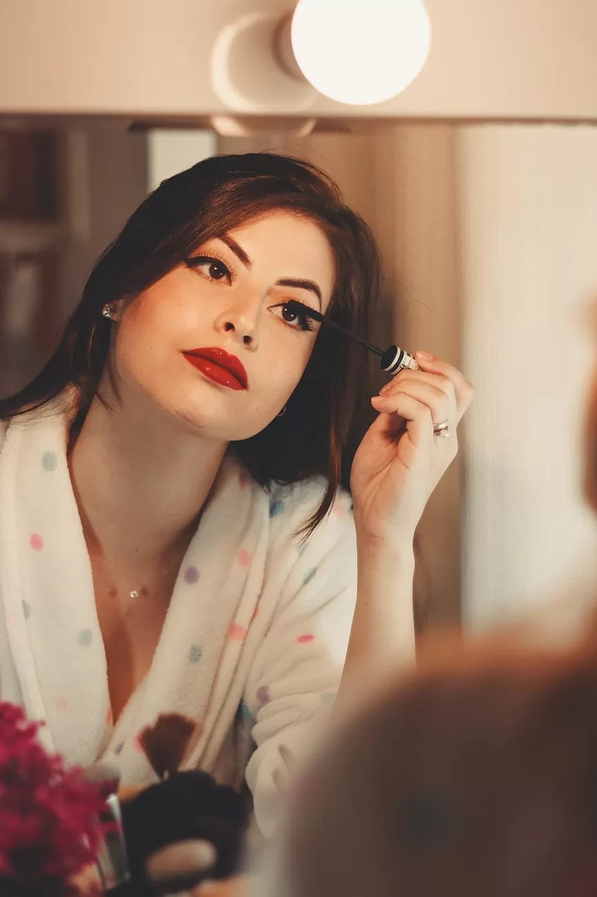 woman applying mascara