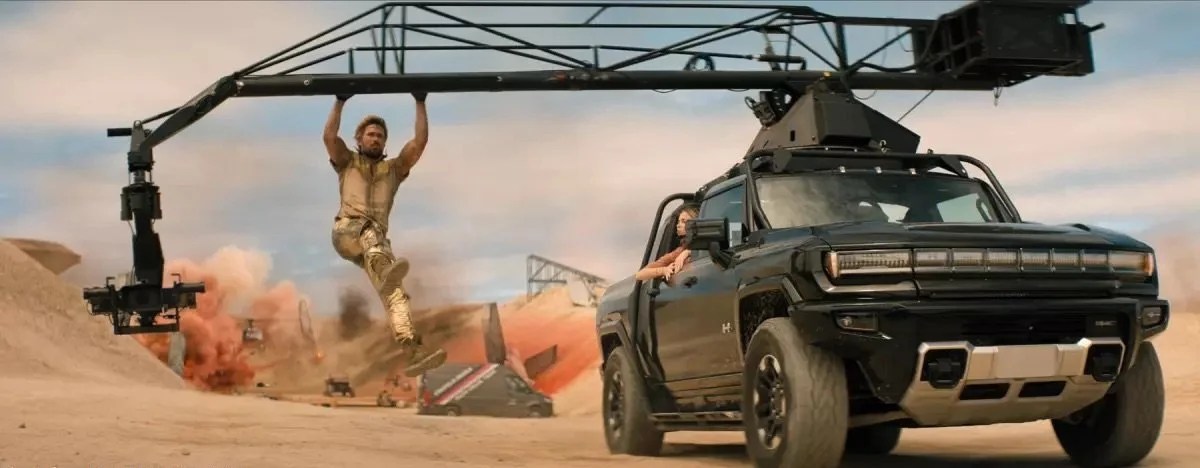Ryan Gosling dangles from a truck in a scene from last year’s action-comedy “The Fall Guy,” which celebrated stunt performers. (Universal Studios)