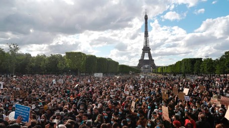 People gather on Champ de Mars in front of Eiffel Tower, in Paris on June 6, 2020