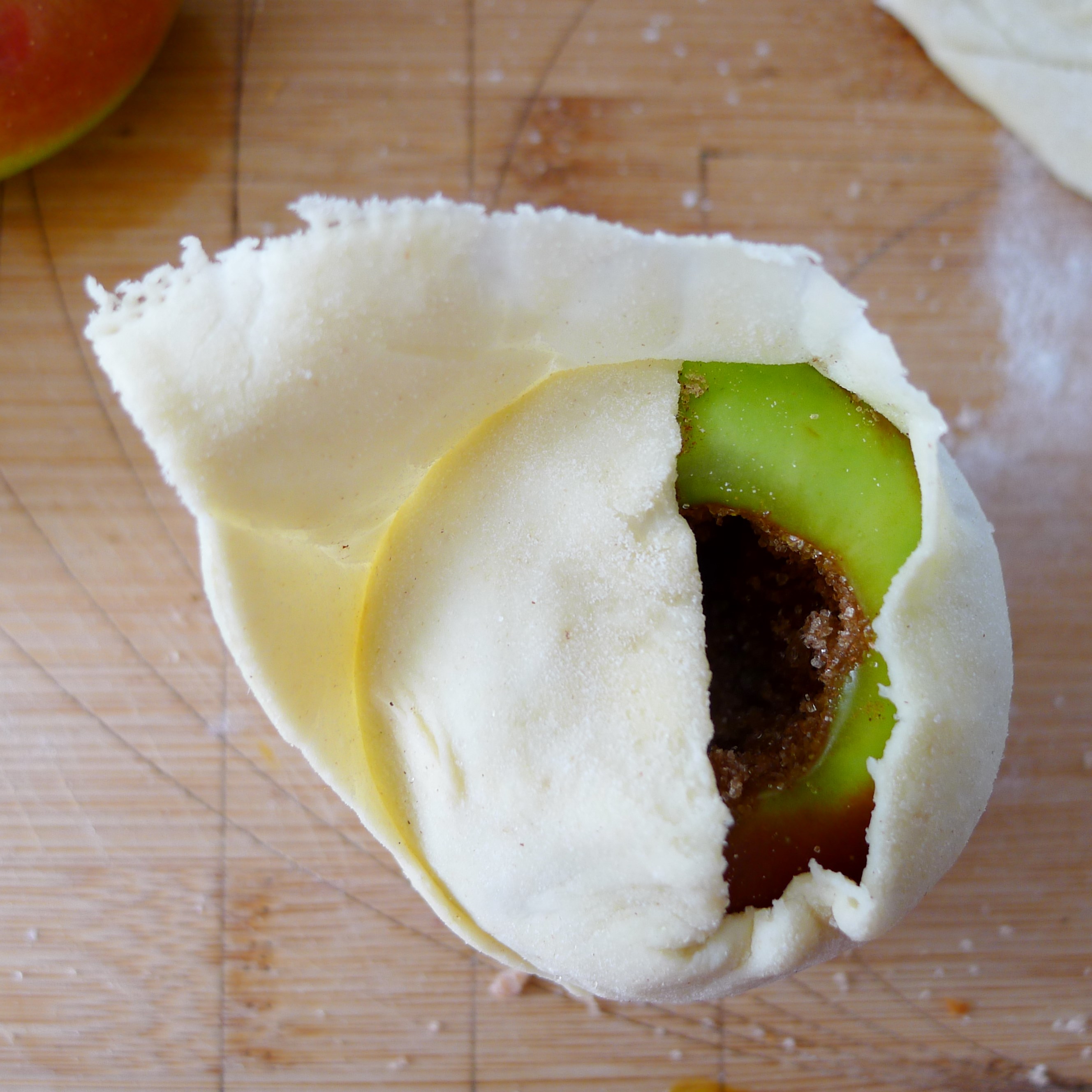 wrapping the dough around apple