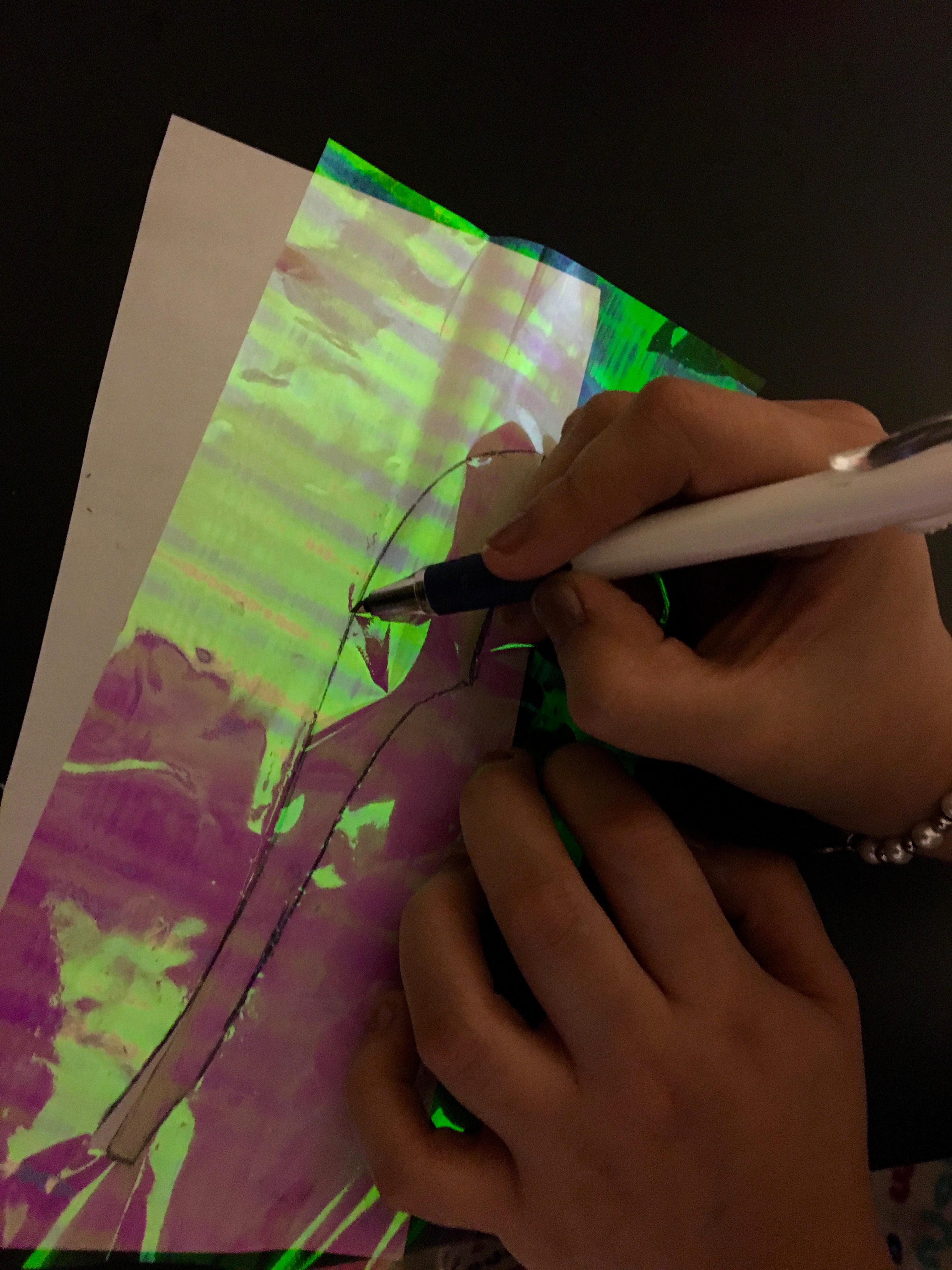 Placing a piece of paper underneath makes it easier to see and cut the outline.