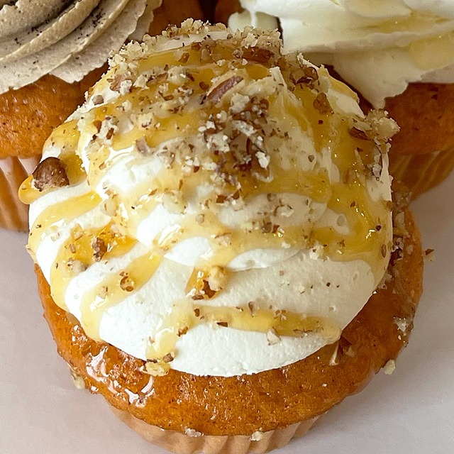 Salted caramel pumpkin cupcake with caramel drizzle and chopped pecans