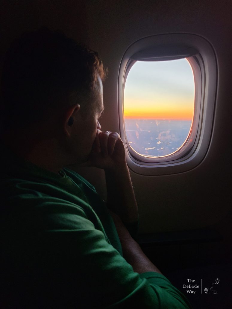 Jason staring out the window on a flight over the ocean