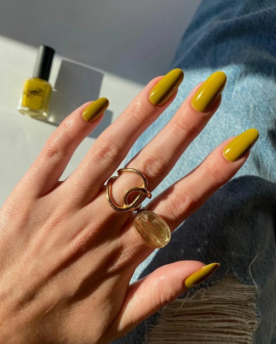 Glossy chartreuse almond nails in a rich yellow-green shade