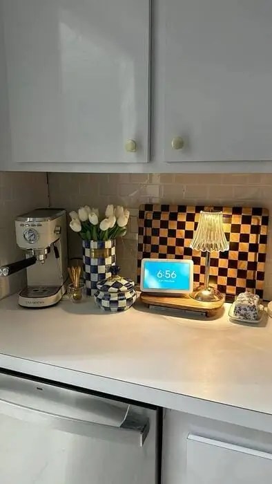 Add a chic black and white counter display to add a sophisticated element in a grey kitchen