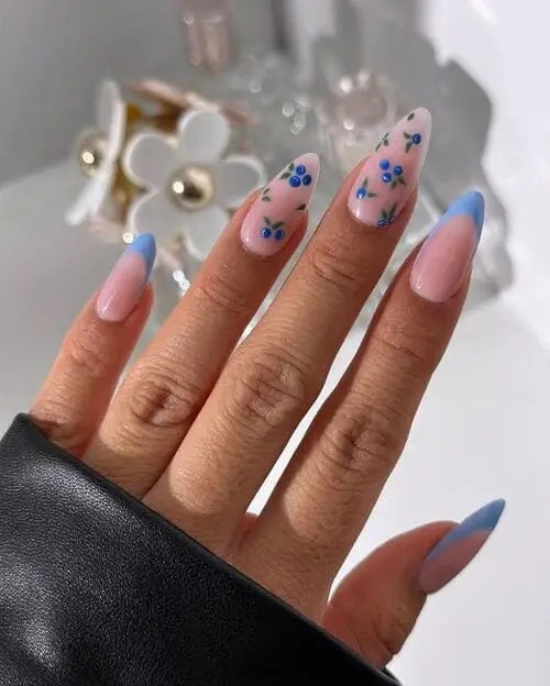 Blueberry accent nails with tiny blueberry designs and crisp blue French tips, trendy summer 2025 nail art.