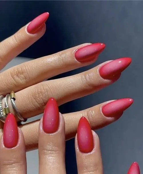 Raspberry aura nails with soft gradient blends of vibrant pink and raspberry shades, trendy summer 2025 nail design.