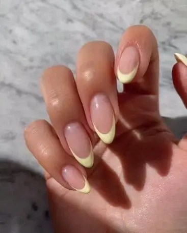 Soft butter yellow french tip nails for summer