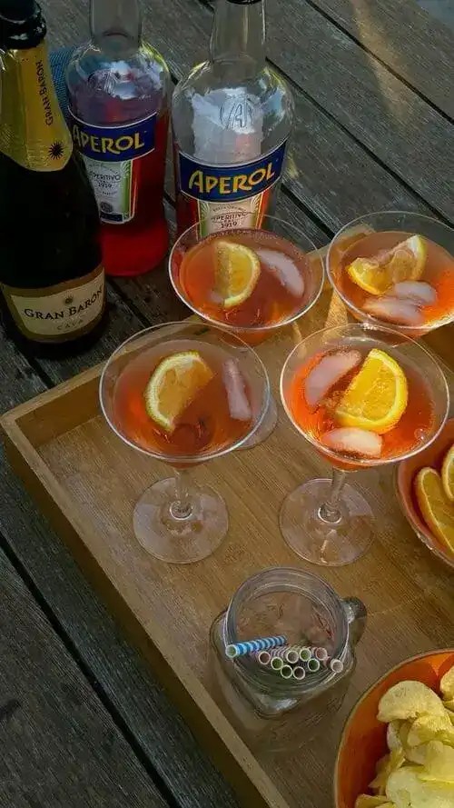 Serve a signature drink at your summer party, like Aperol Spritz's, to turn your small apartment into a mediterranean escape.