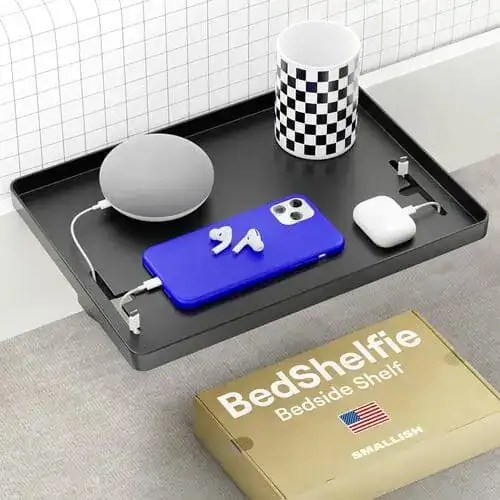 A dorm hack you need is a clip-on bedside shelf if you don't have a nightstand.