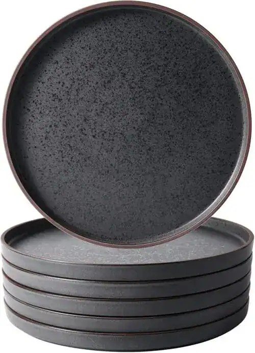 Chic black ceramic plates add an elevated touch to picnic style summer party in small apartment