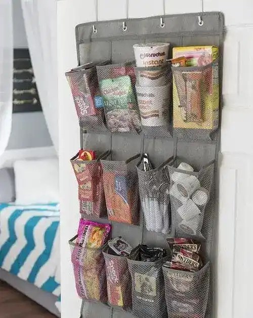 Over-the-door clear shoe organizer used for dorm room storage—perfect for organizing snacks, toiletries, and school supplies in small spaces.