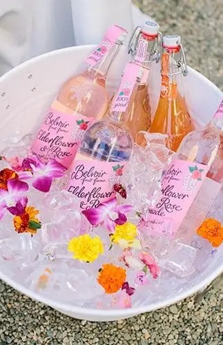No room for a giant cooler? No problem. Fill a few cute drink buckets or large bowls with ice and pop them around your space. They’re easier to tuck into corners, look way cuter, and keep drinks chilled without hogging your floor. Bonus: they double as decor if you get creative with colors or labels.