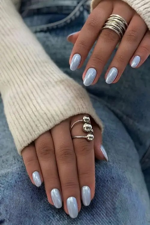 Light blue chrome summer nails in soft sky and periwinkle tones; elegant, glossy manicure with subtle shimmer perfect for classy events or everyday summer style.