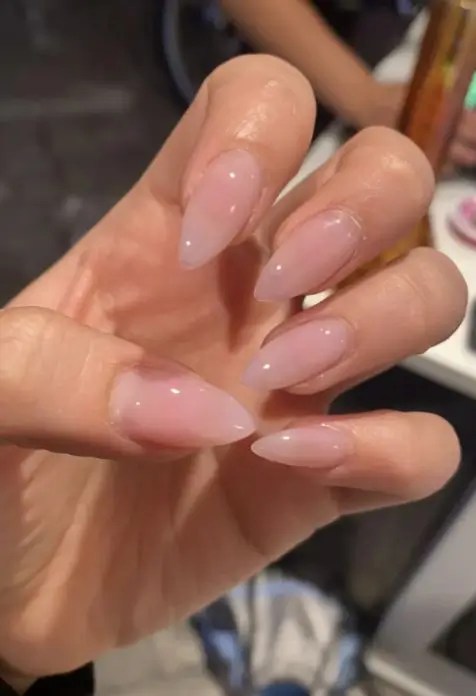 Minimalist light pink clear nails with a sheer glossy finish, perfect for a classy and natural summer manicure look.