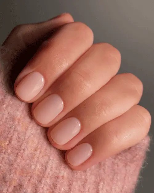 Short glossy summer nails in nude and pastel tones with a high-shine finish - elegant and clean manicure style for warm-weather minimalism.