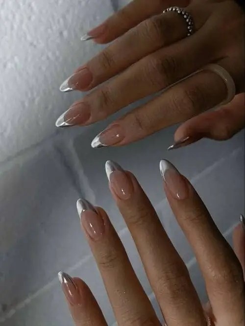 Modern silver French tip nails with a nude base, combining edgy metallic detail with classic summer elegance.