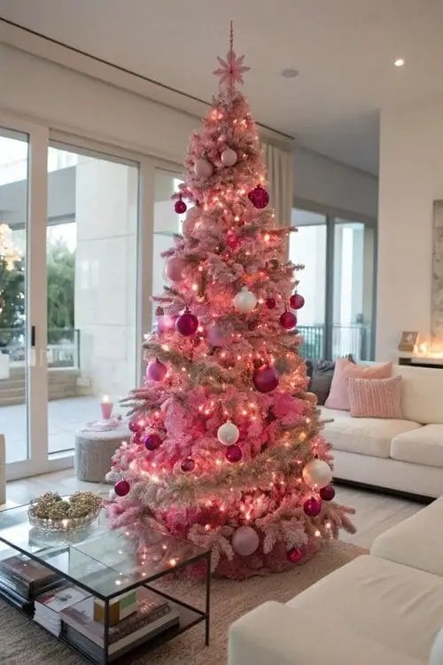 Barbiecore-inspired Christmas tree decorated in pink ornaments, bows, and lights with matching pink wrapped presents underneath. Cozy fireplace with pink stockings and wreaths in the background, creating a glamorous holiday look.