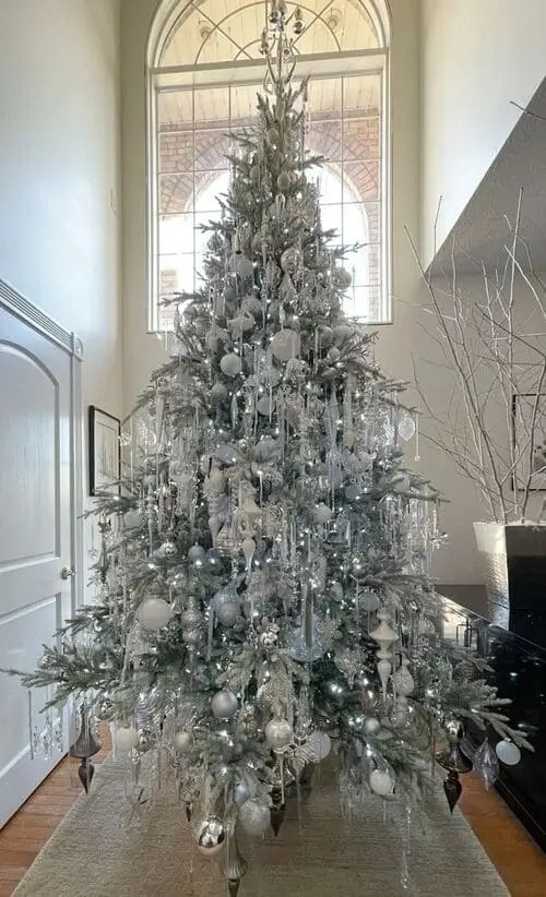 Silver icicle Christmas tree decorated with cascading icicles, silver ornaments, and shimmering baubles for a luxe winter wonderland look