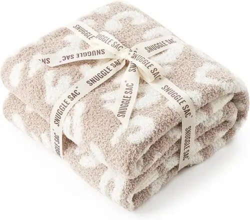 Neutral beige and white leopard print throw blanket tied with ribbon — cozy and aesthetic Christmas gift for teen girls under $30.
