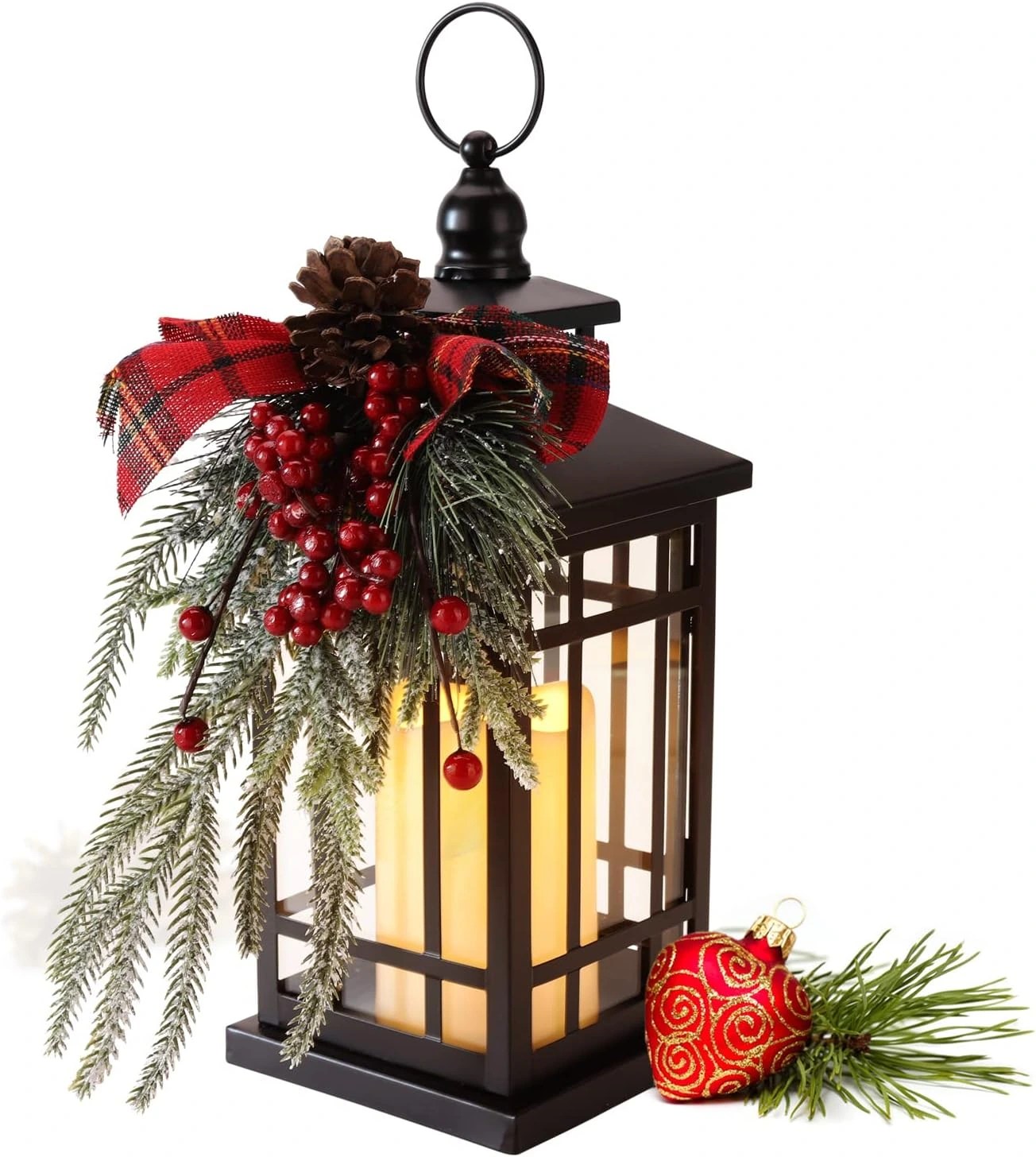 Black Christmas lantern with a glowing flameless candle, frosted evergreen, red berries, pinecone and plaid ribbon accents.