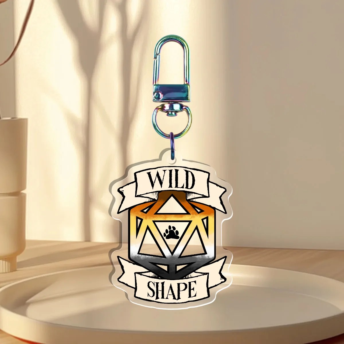 Keychain Design – D20 die filled with the bear flag with a banner that states “Wild Shape”, back with is clear without iridescent holographic overlay