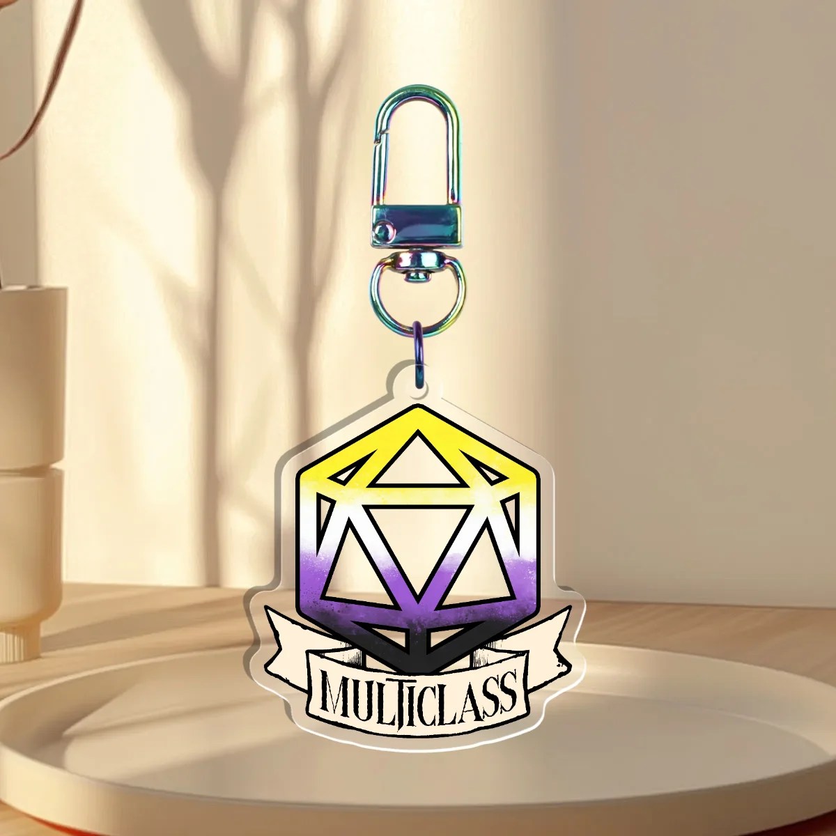 Keychain Design – D20 die filled with non-binary flag with a banner that states “multiclass”, back is clear without iridescent holographic overlay