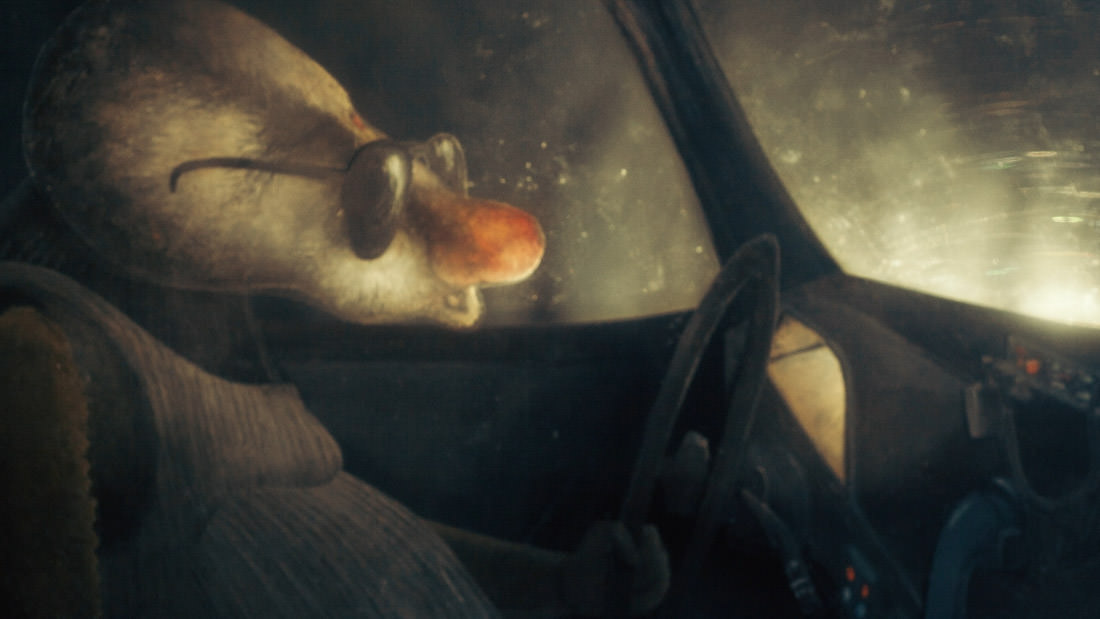 A person smoking inside a car with sunlight filtering through.