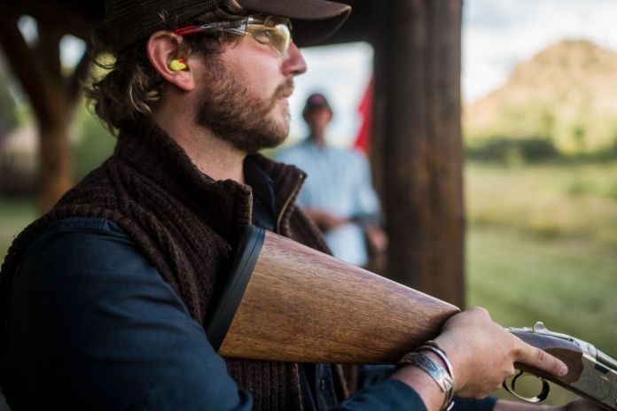 shouldering a shotgun