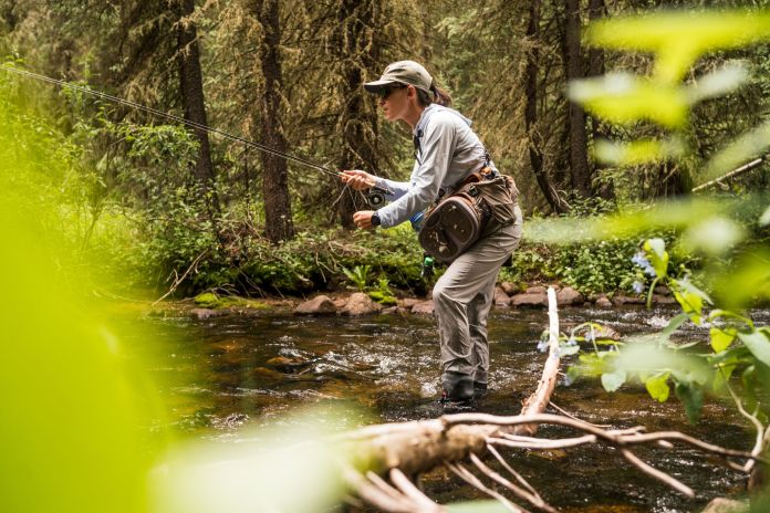 emily fishing in a small creek 