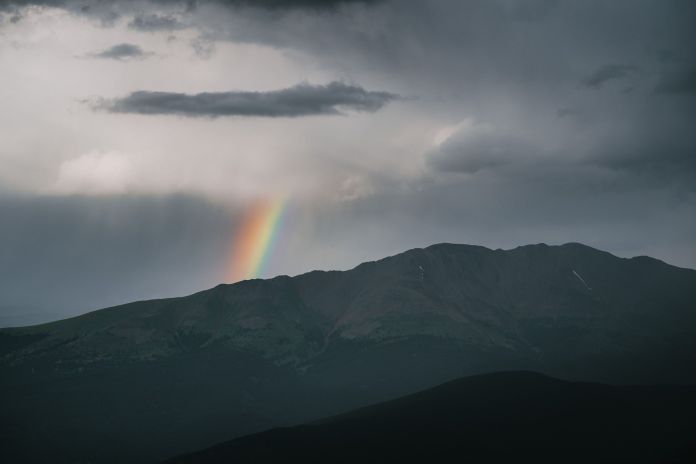 photo of a rainbow and incoming rain 