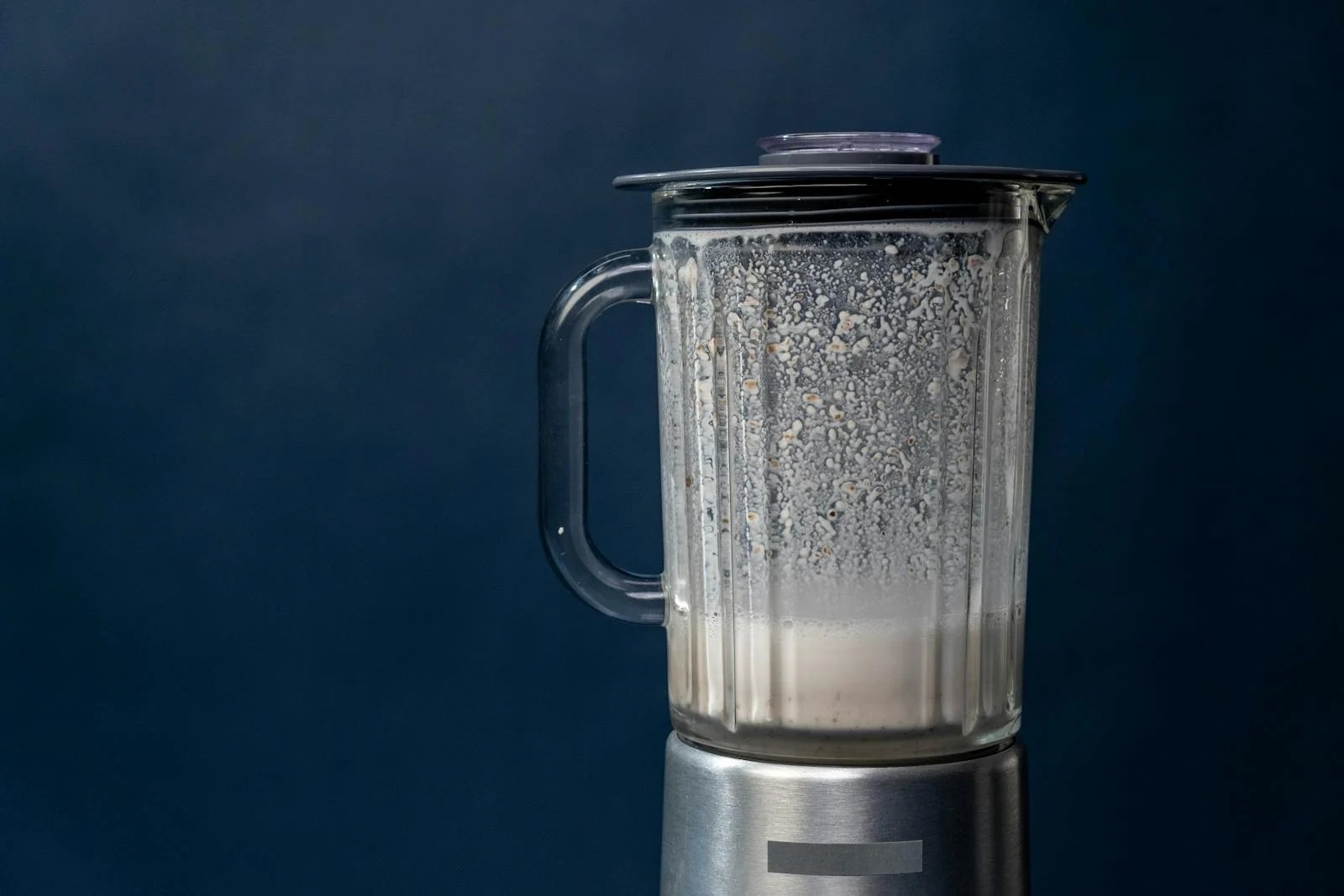Zacusca Recipe- Delicious Romanian Spread In 3 Hours 6 Close-up of a silver blender making a milkshake against a blue background, studio shot.