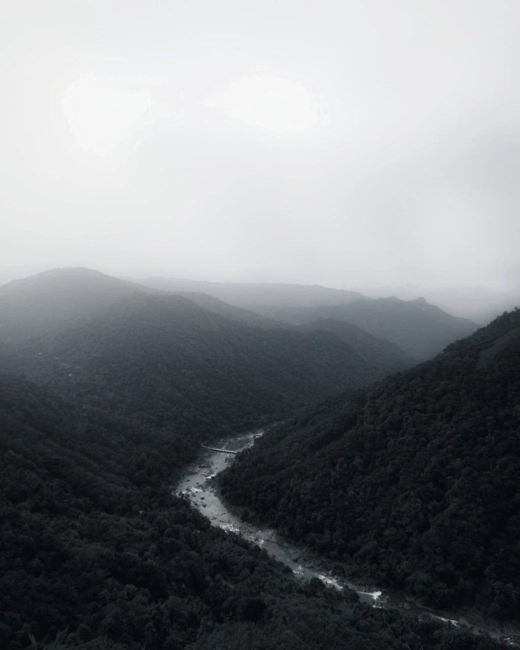 aerial view of mountains and river in the valley