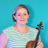 Portrait of a smiling woman in a striped shirt, holding a violin against a turquoise background