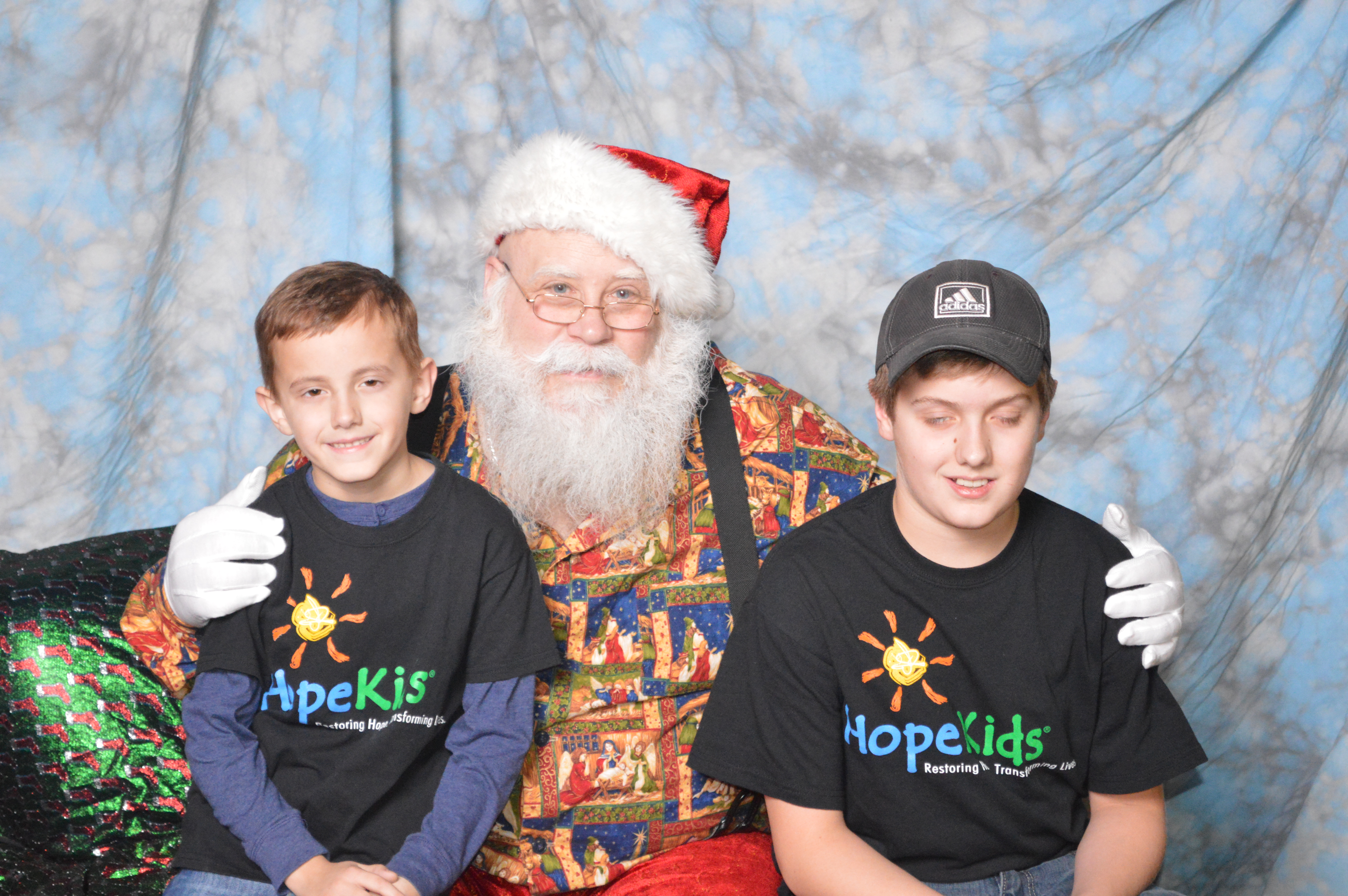 Santa with partial eyes closed and total eyes closed kids!