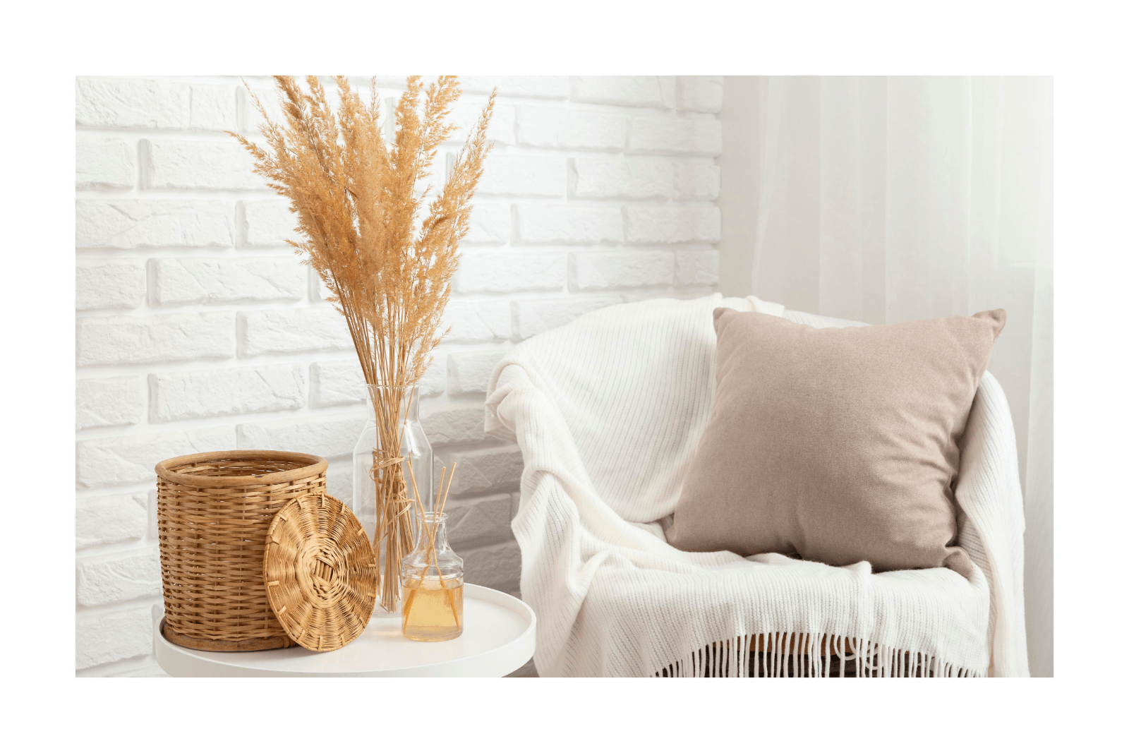 A cozy chair with a blanket and pillow beside a small table with a vase and basket - gentle slow decluttering for when life feels heavy