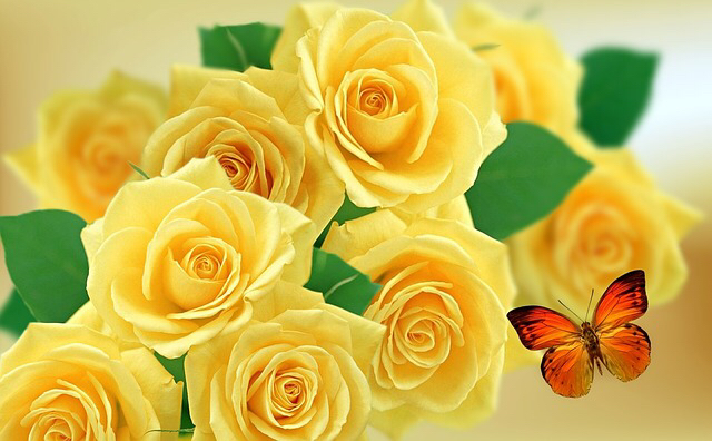 A bouquet of yellow roses with a little butterfly on the side