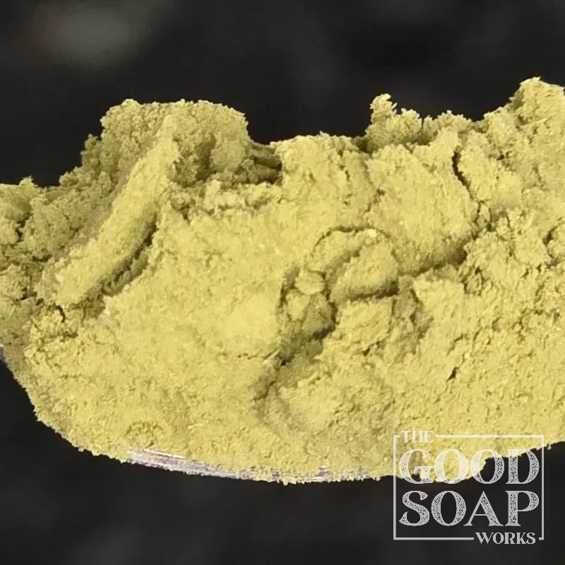 Matcha powder on a wooden spoon — a vibrant green tea powder used as a natural colorant in handmade soap