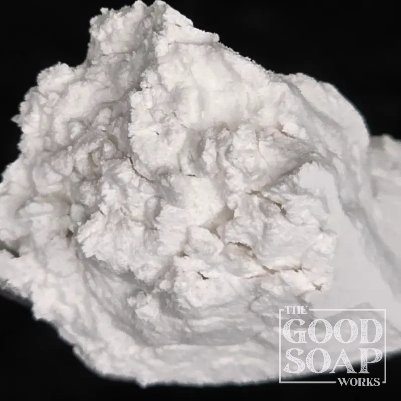 Pumice powder on a wooden spoon — a natural volcanic mineral used as an exfoliant in handmade soap