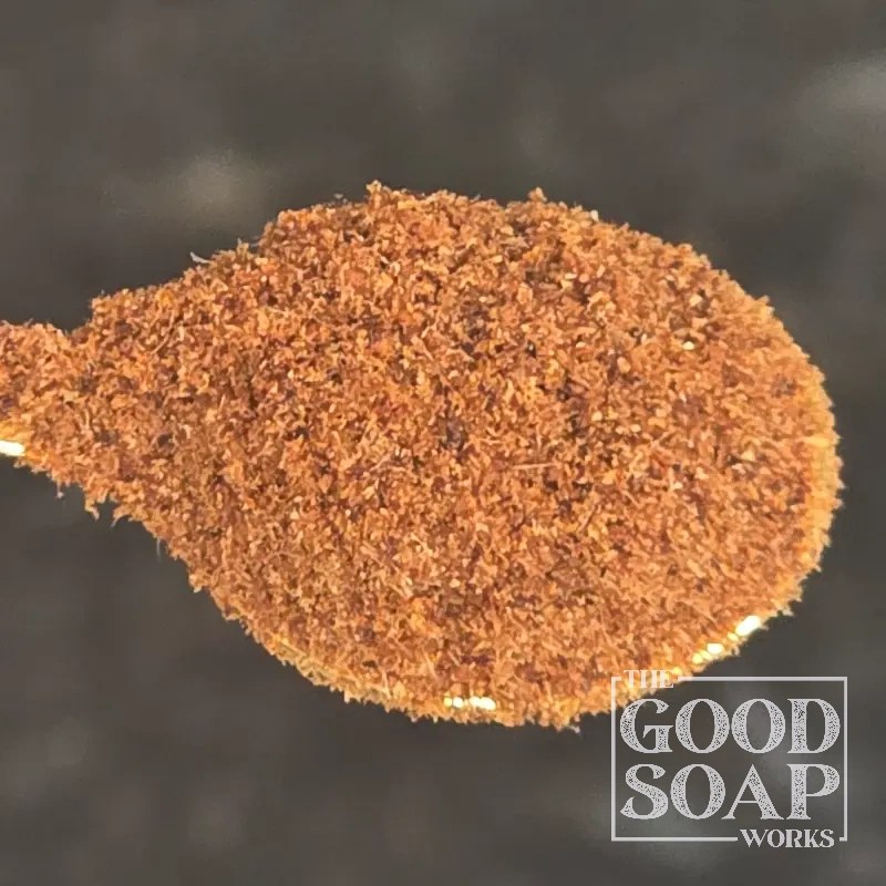 Rosehip powder on a wooden spoon — a natural botanical ingredient and colorant for handmade soap and skincare
