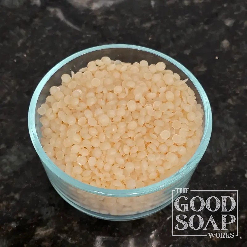 Close-up of Zinc Ricinoleate powder on a spoon, a natural deodorizing ingredient used in skincare by The Good Soap Works Co.