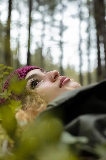 A woman forest bathing to increase her focus and decrease her anxiety.