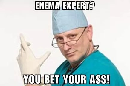 Photo of a doctor in green scrubs and wearing a surgery cap who is putting on a white glove with a suspicous look on his face.