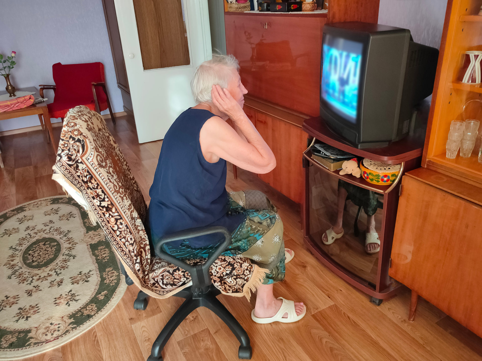 man with hard time hearing with the tv on
