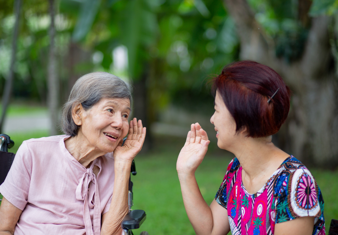 two women talking and having difficulty hearing