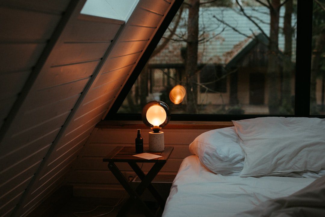 Warm bedroom lighting near bed and nightstand