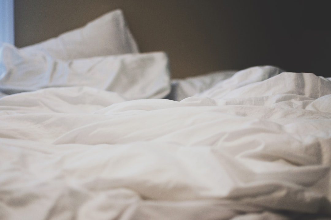 Neatly made bed with folded blanket