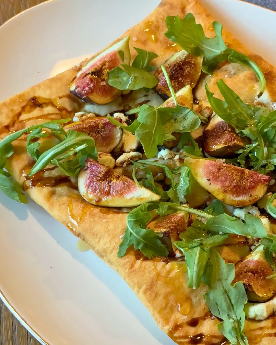 Balsamic fig and goat cheese flatbread topped with arugula