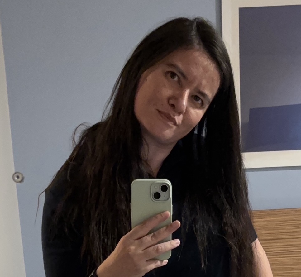 A headshot of Nicolette Langendam (relected in a mirror).