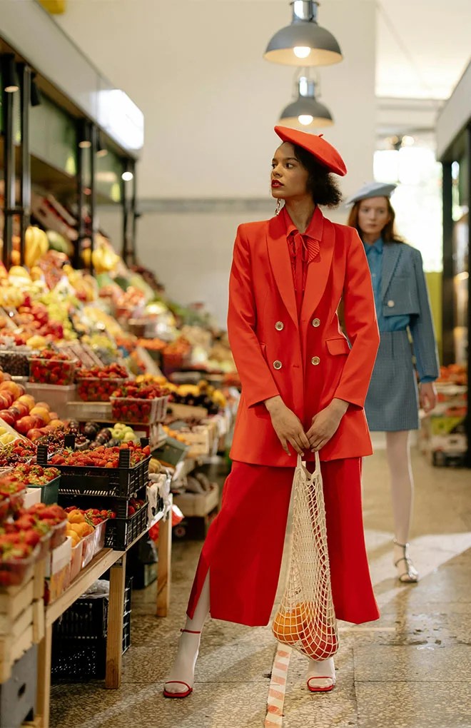 Photo of a model in a red suite shopping at a grocery supermarket
